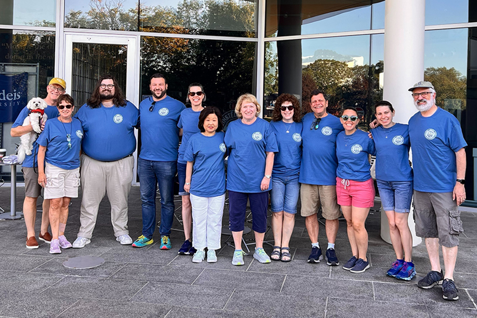 Group of alumni volunteers in blue shirts