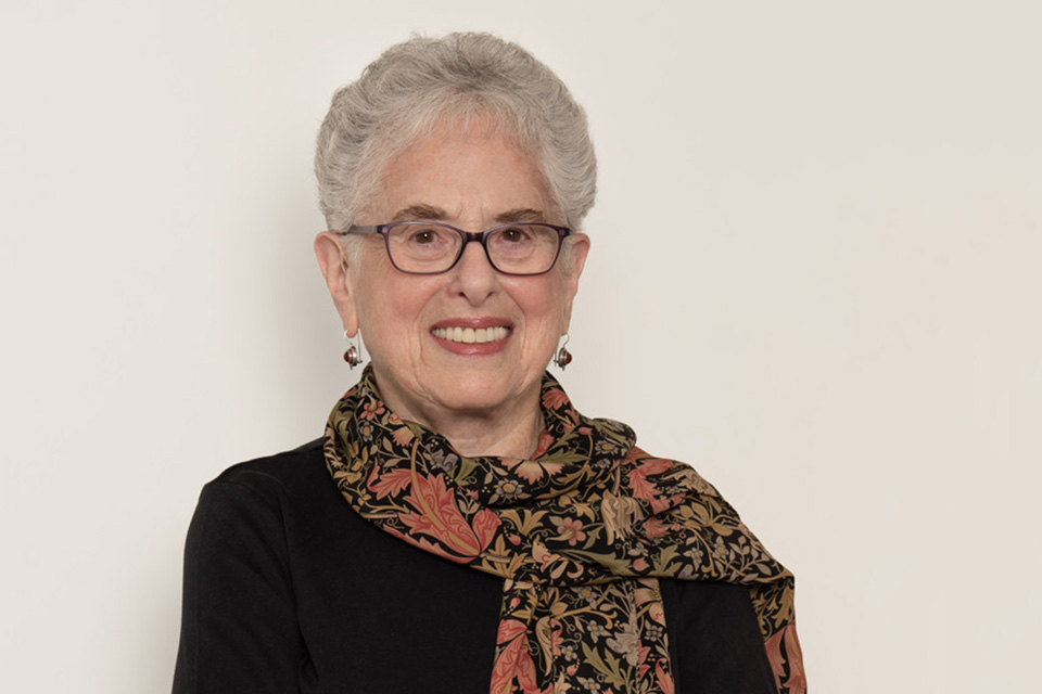 Sheila Efron Taube '63 in a black sweater and flower-patterned scarf