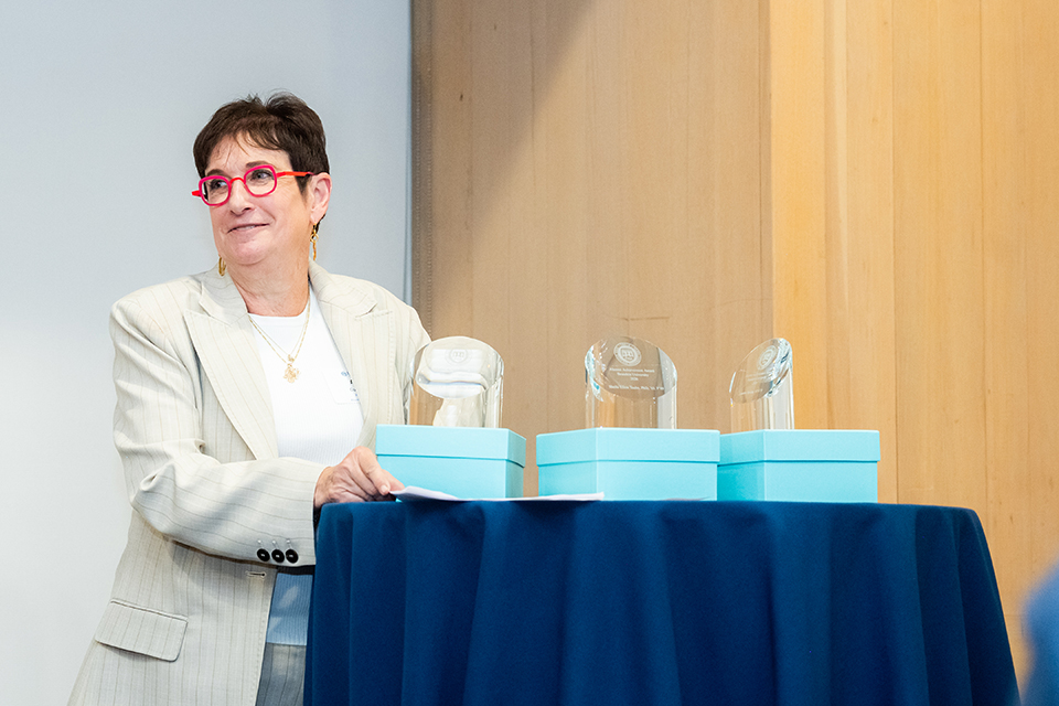 Amy Cohen at the podium giving out the alumni achievement awards