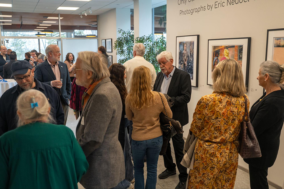 Person is photographed at an alumni art gallery show