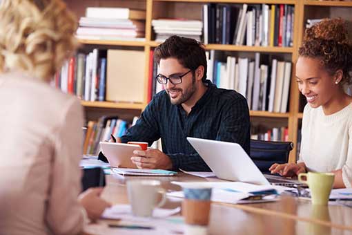 A group of people working at a conference table. 