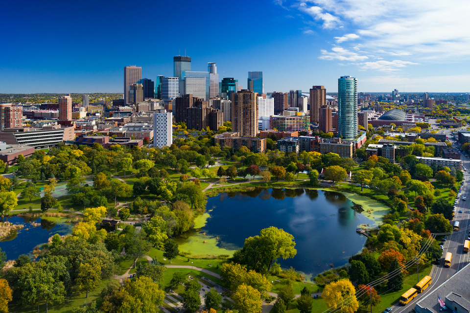  Minneapolis aerial with Downtown Minneapolis skyline in the background and Loring Park with Loring Pond in the foreground, during early autumn.