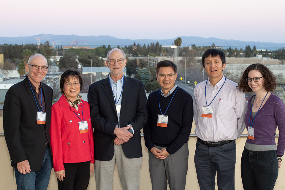 A group of alumni volunteers pose for a photo with Nobel laureate Professor Michael Rosbash.