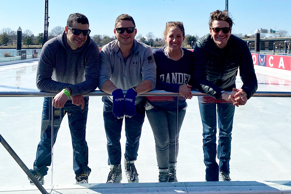 Brandeis Alumni posing on ice skates for a phot in DC
