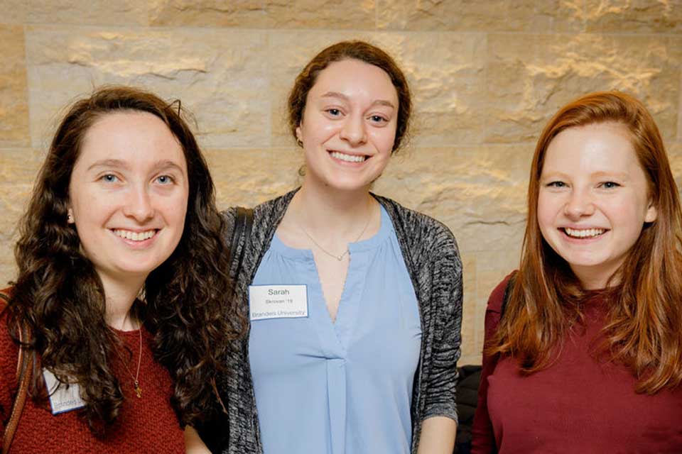 Three young alumni smiling at Womens Network event 