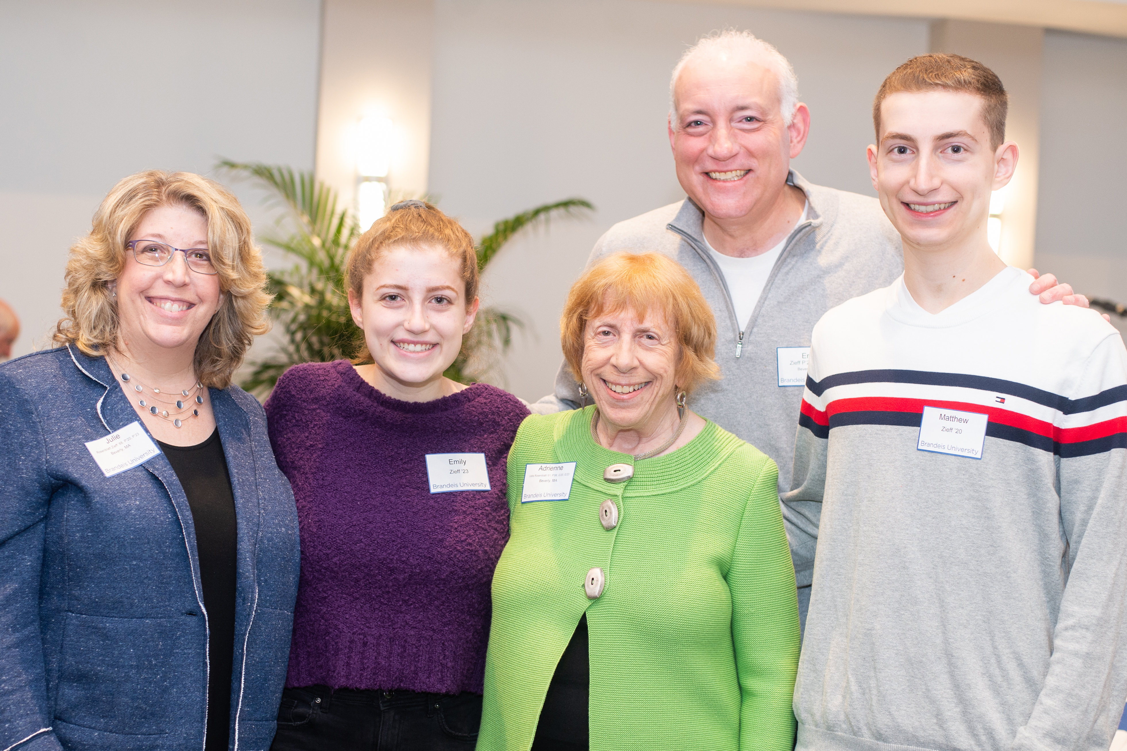 Five family members of various ages smiling and posing for a photo.