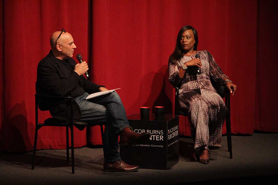 Brian Ackerman on stage interviewing Dr. Serena McCalla at the Jacob Burns Film Center 