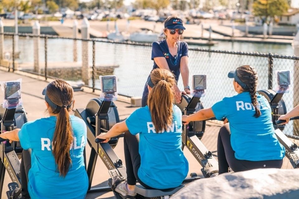 Liz Attardo Greenberger instructs students on practice rowing machines