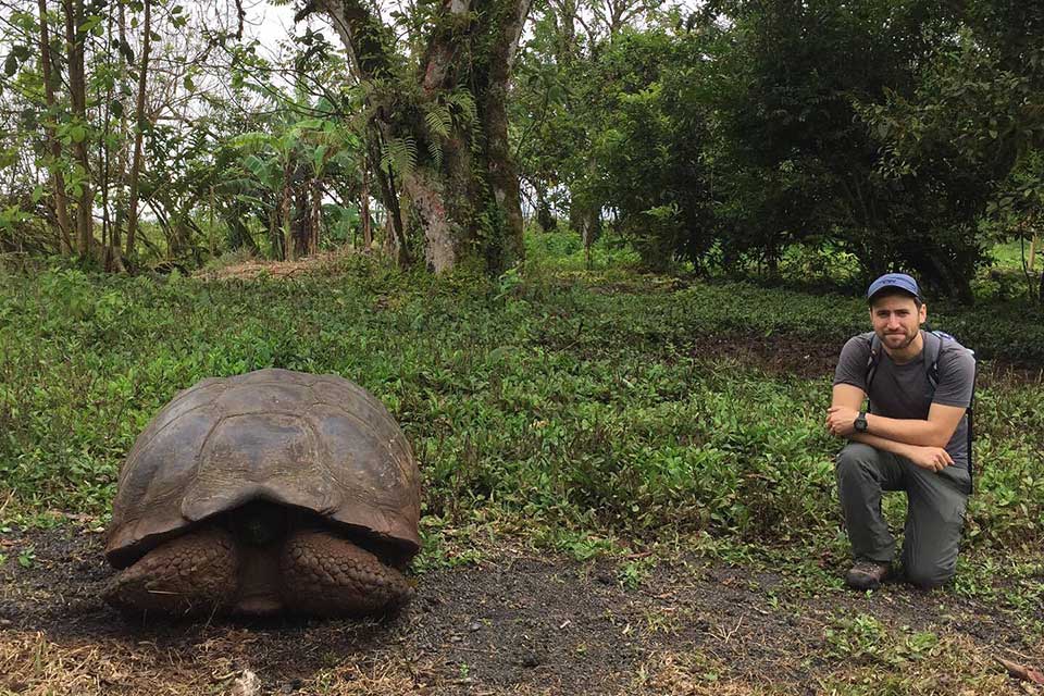 Harrison Goldspiel next to a giant tortoise