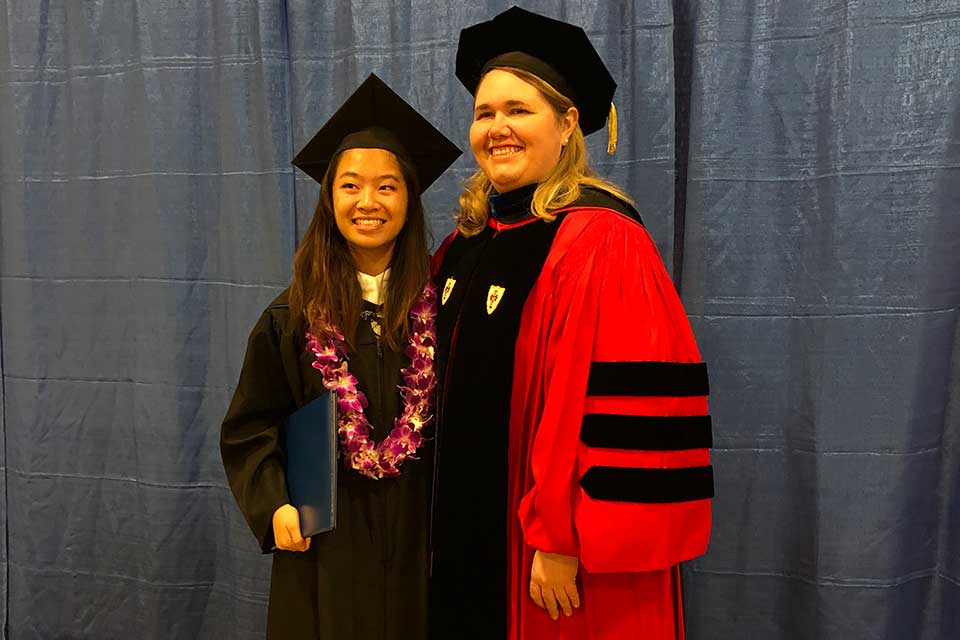 Helen Wong and Alexandra Ratzlaff in graduation robes