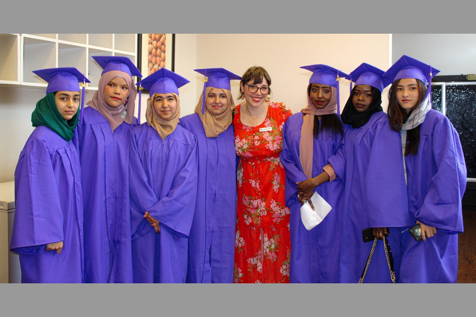 Global Village Project Education Director Hannah Edber, a 2009 Brandeis graduate, stands with graduates of her school in May