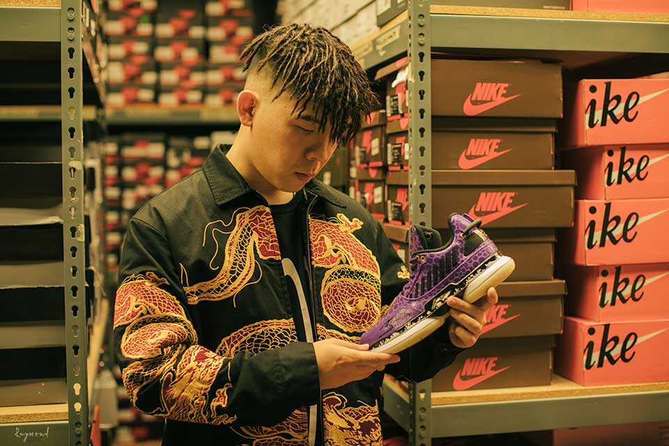 Jiahuan Green Xia looks at purple and black sneaker 