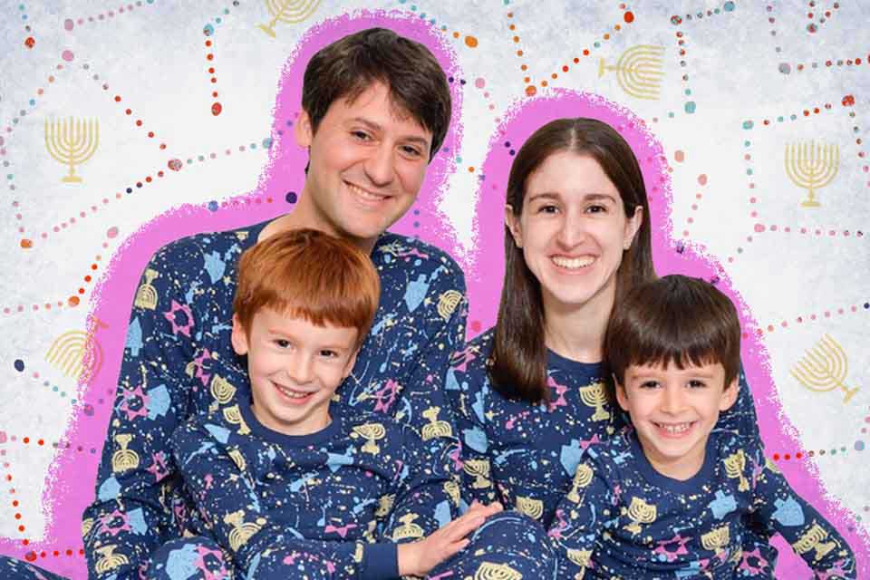 Family of four posing in Hanukkah pajamas.