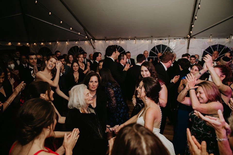 Erica on the dancefloor with her Baba surrounded by dancing wedding guests