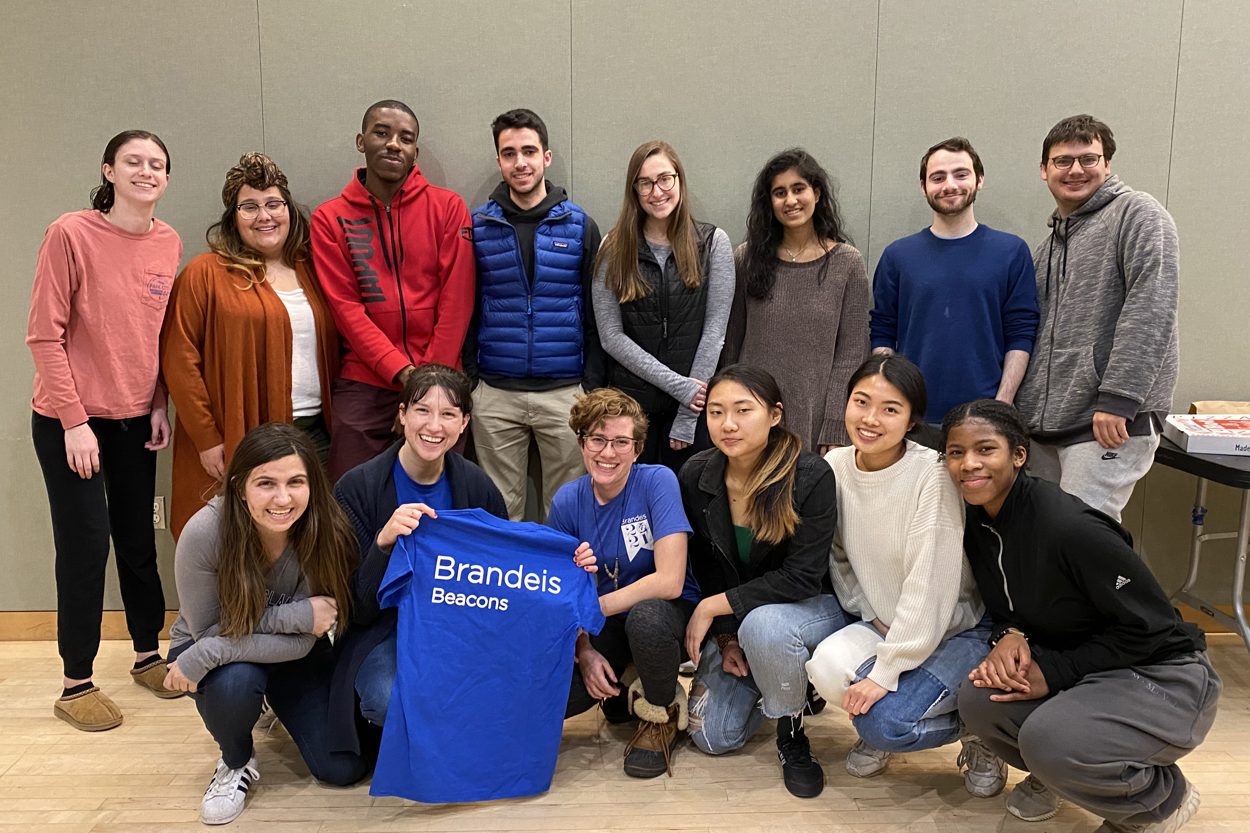 Members of the Brandeis Beacons posing together in the Shapiro Campus Center Multi-Purpose Room at their February Meeting.